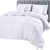 A neatly made bed with a gray tufted headboard features the Downlite White Goose Down Duvet Insert | Midweight by Downlite, a hypoallergenic, 600 fill power comforter that looks soft, fluffy, and inviting as it drapes over the sides.