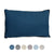 A rectangular Pillowtex Dream in Color pillow, featuring a dark blue hue and black piping, enhances the scene. Beneath it are six circular color options displayed on a pristine white background: dark blue, gray, beige, light lavender, light blue, and white. This hypoallergenic down alternative pillow by Pillowtex combines style with comfort.